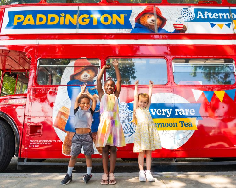 Three kids next to paddington afternoon tea tour bus