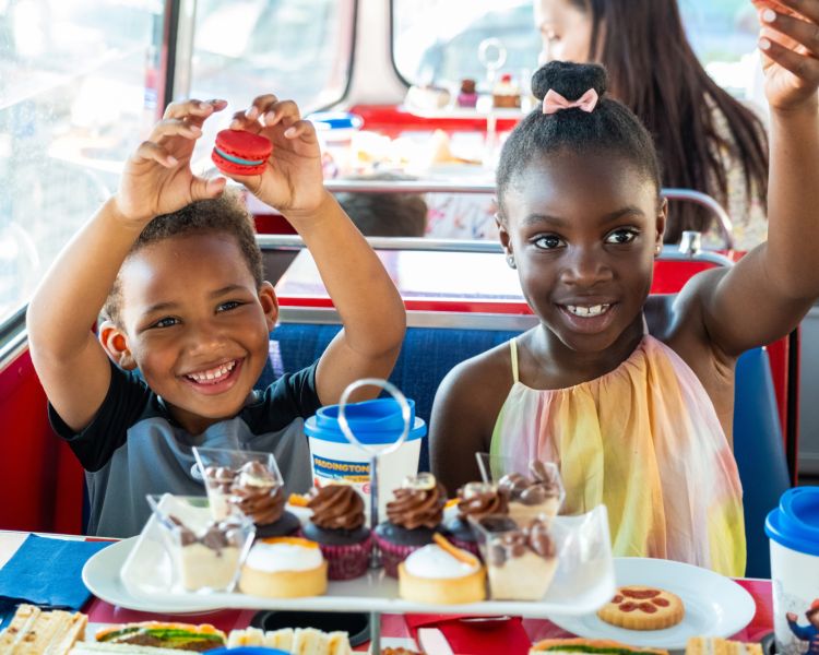 Young boy and girl on paddington afternoon tea bus tour