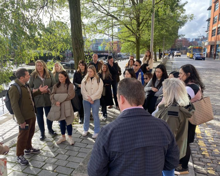 Tour group alongside canal on manchester food tour