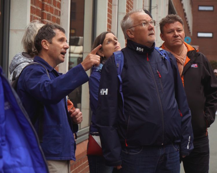 Tour guide talking to group on manchester food tour