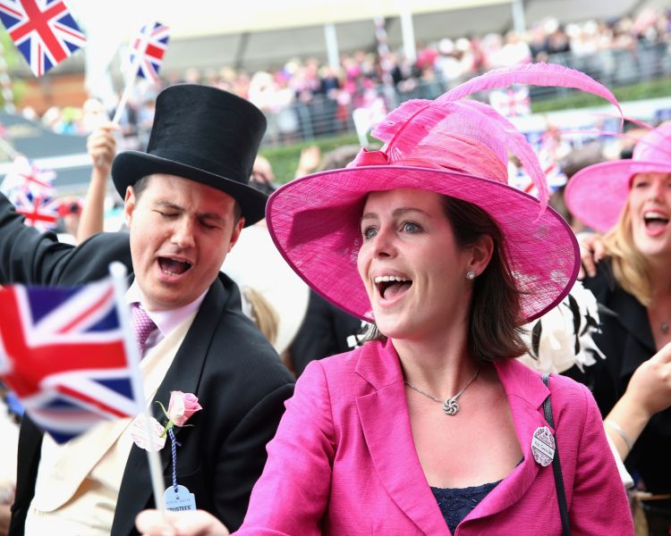 Guests cheering with flags at royal ascot