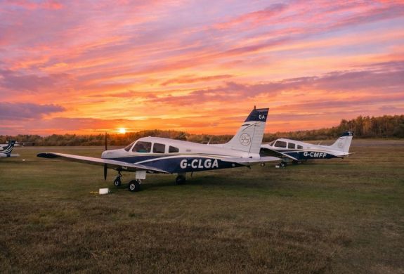 Sunset over two parked planes on airfield
