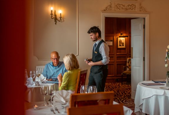 Waiter taking order from couple at bagden hall restaurant