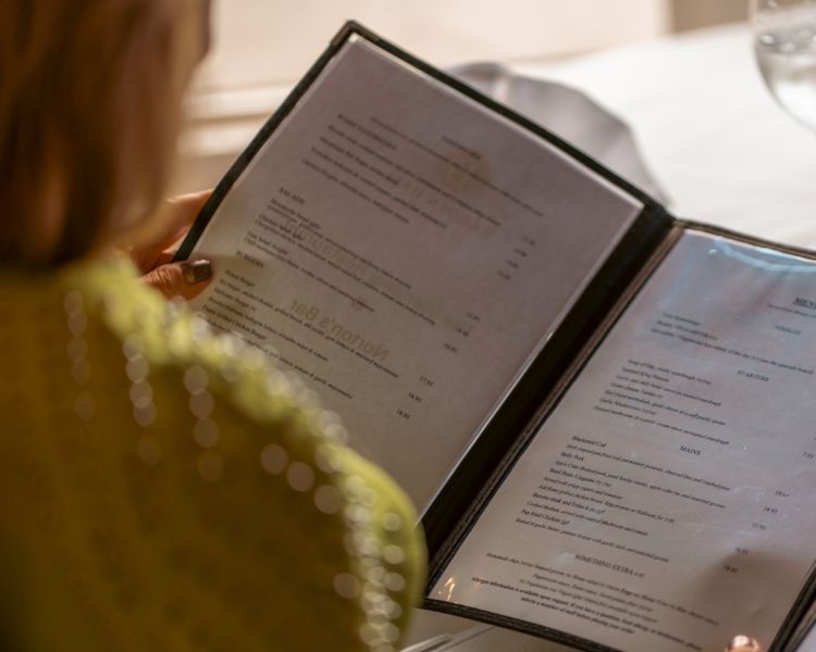 Woman reading menu at bagden hall restaurant