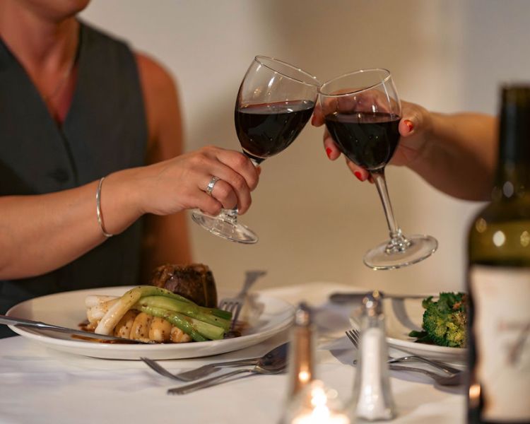 Ladies at dinner with wine at grinkle park hotel