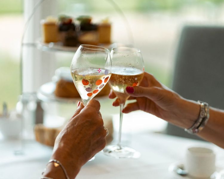 Ladies with champagne at grinkle park afternoon tea