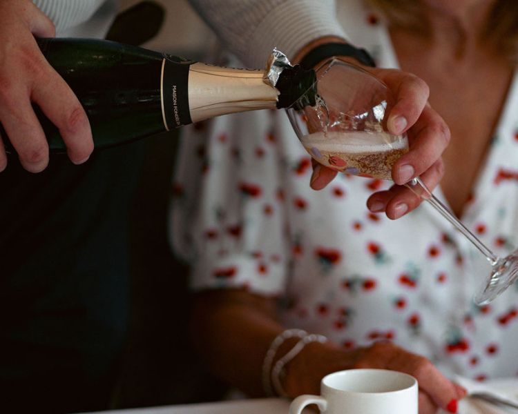 Waiter pouring champagne at afternoon tea at grinkle park