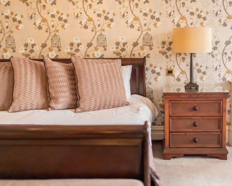 Double bed with side table and lamp at grinkle park hotel