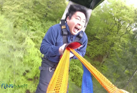 man on a bridge swinging experience day