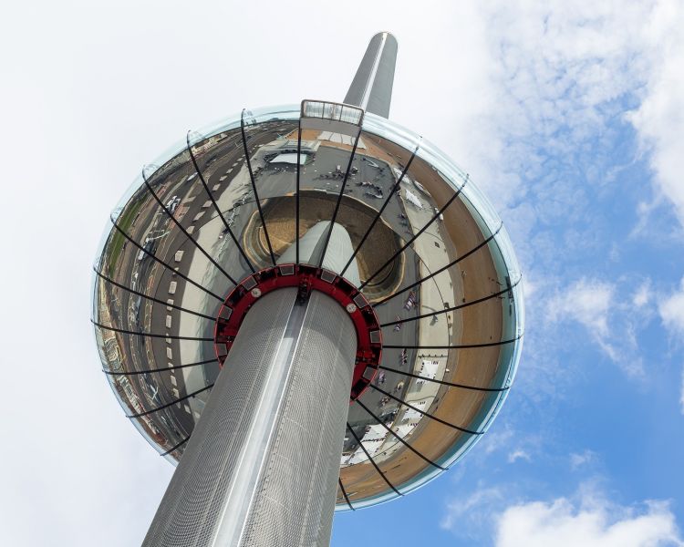 brighton i360 pod against a cloudy blue sky