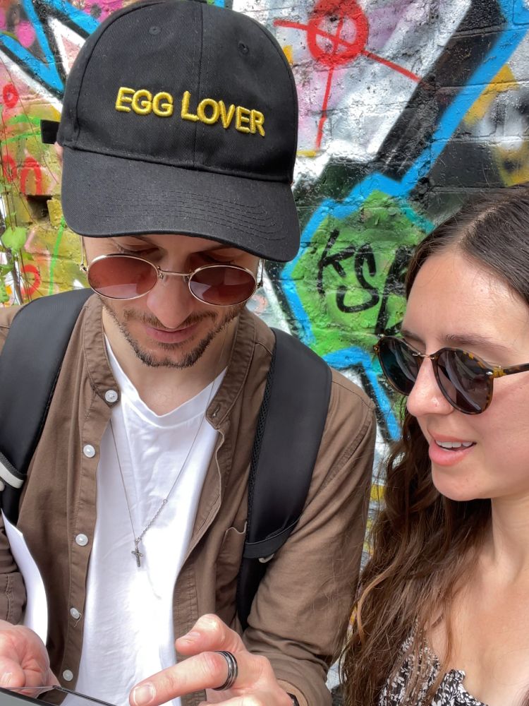 Couple looking at phone on a mystery food tour in london