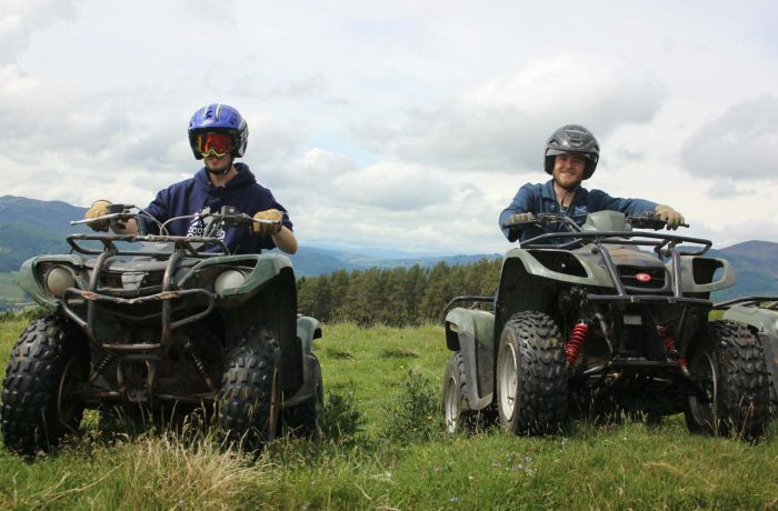 two people on quad bikes on a hill side on a quad biking experience day