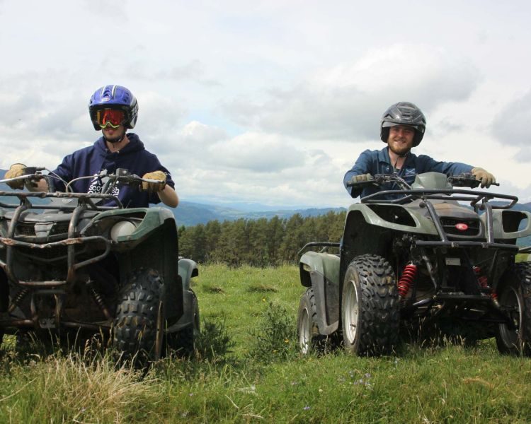 two people on quad bikes on a hill side on a quad biking experience day