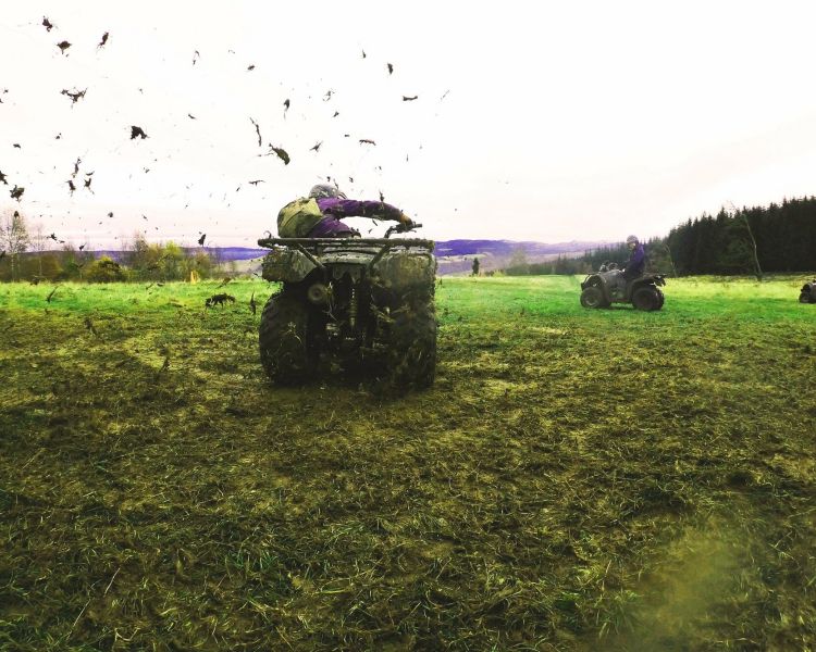 person on a quad bike riding around on grass on a quad bike experience day