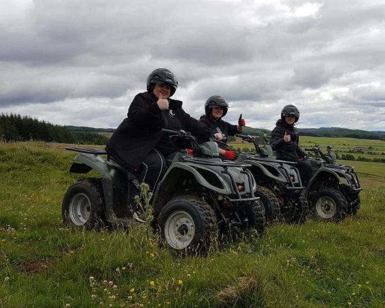 three people on quad bikes giving the thumbs up on a quad bike experience day in the coutryside