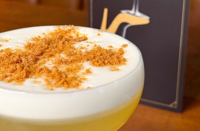Close up of a cocktail and menu