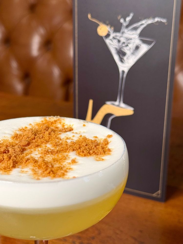 Close up of a cocktail and menu