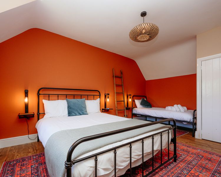 Bedroom with double bed and a single bed at cottage