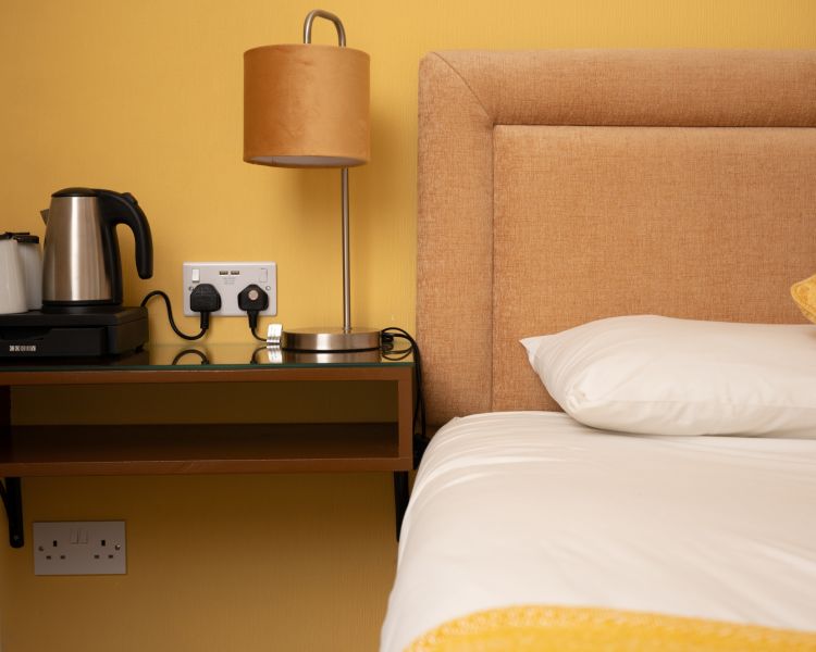 Double room bedside table at zip world inn