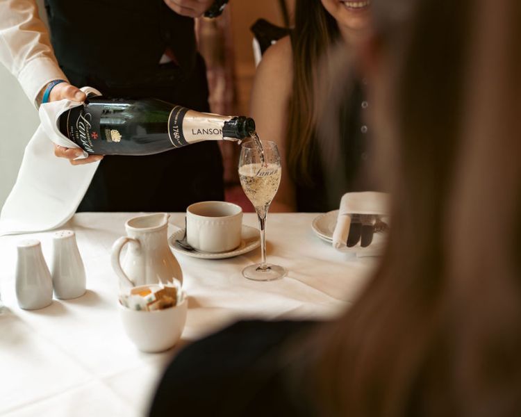 Pouring champagne for afternoon tea at farington lodge