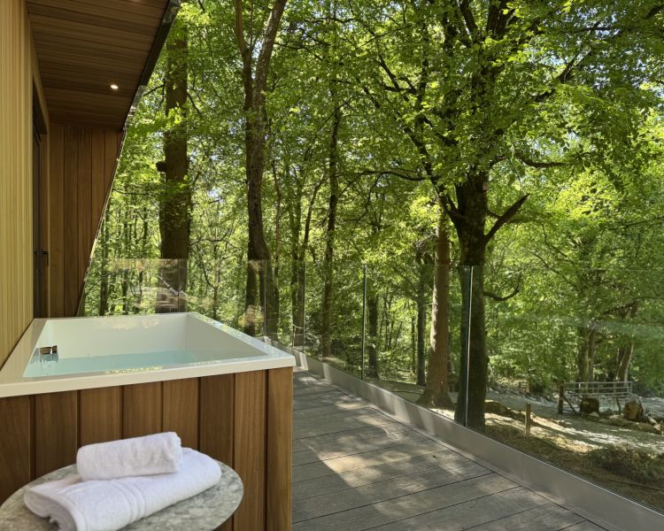 Zip world forest lodge with outdoor bath on balcony