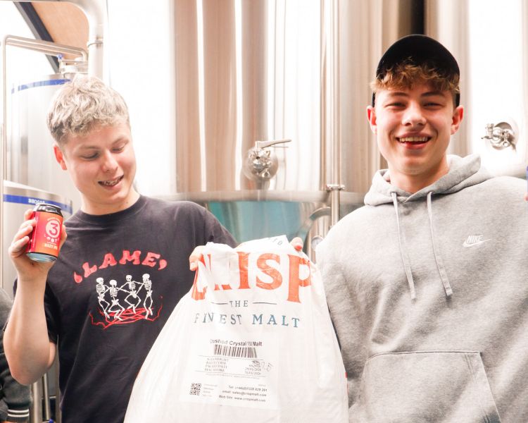Two lads holding a sack of malt at 3 locks brewery in camden
