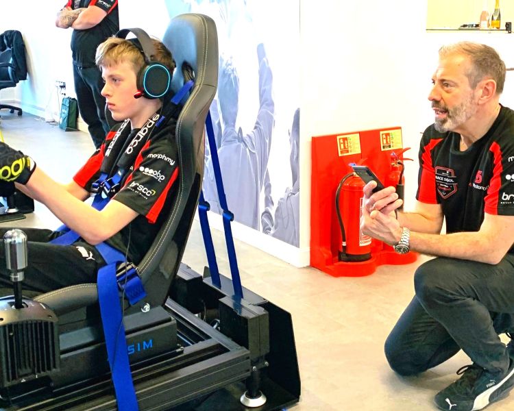 A boy on the motosports simulator
