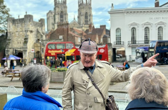 guide talking to group on a historical walking tour in york