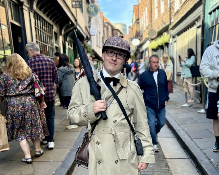 tour guide on busy street on a historical walking tour in york