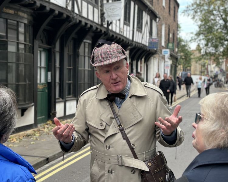 guide talking to group on york street on a historical walking tour in york
