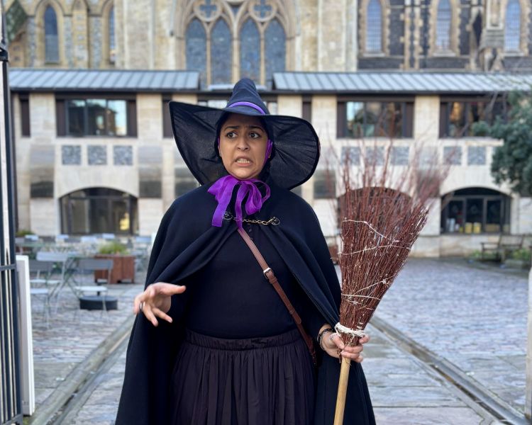 guide talking to group on a witches walking tour in london