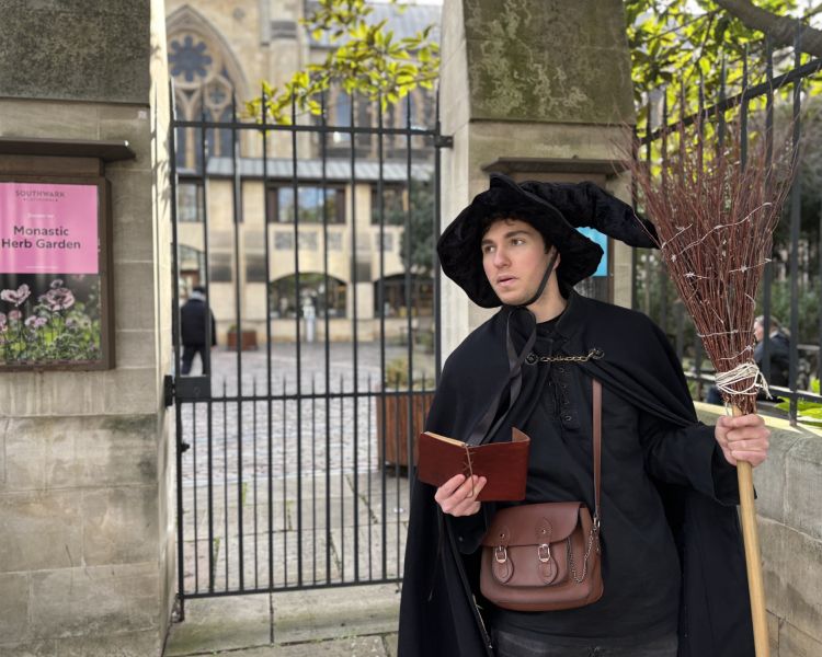 guide by metal gate on a witches walking tour in london