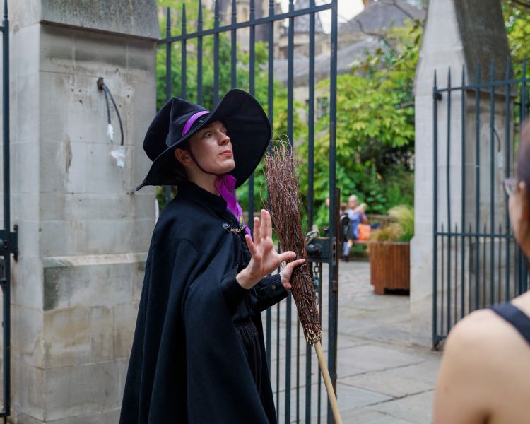 guide talking to group on a witches walking tour in london