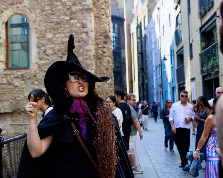 guide talking to group on a witches walking tour in london