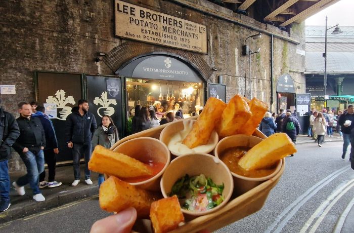 Chips and dips held up in front of chip vendor in borough market