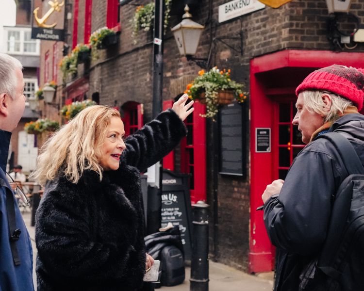Guide pointing to building on london borough market food tour