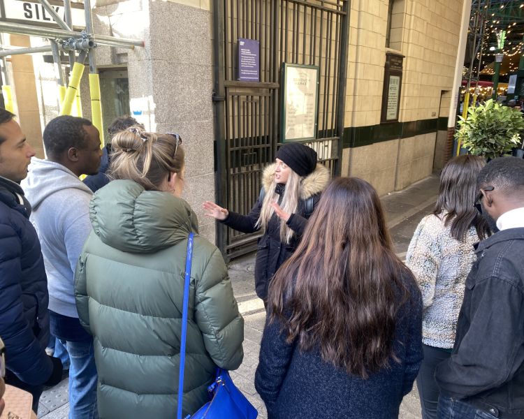 Guide talking to group outside borough market on london food tour