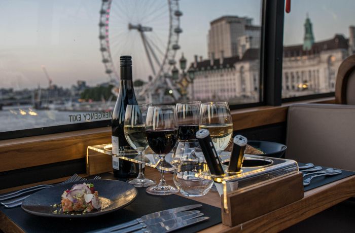 View of london eye from table set for dinner on bustronome london dining bus