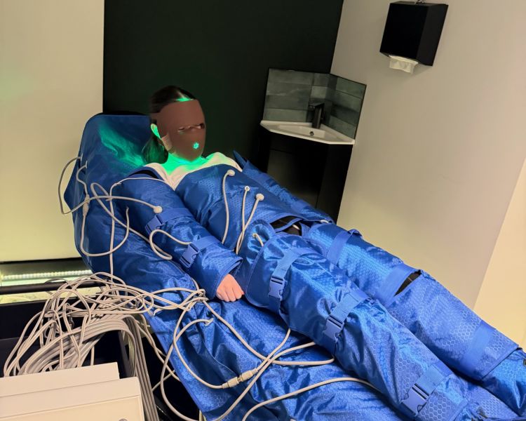 Woman wearing full body lymphatic drainage suit for treatment