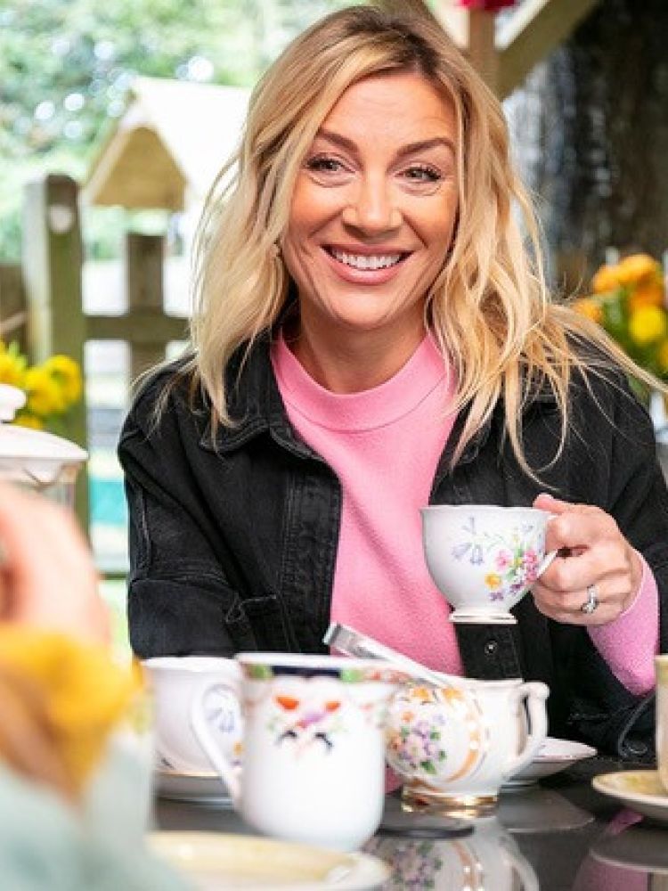 woman having a cup of tea in orchard cafe