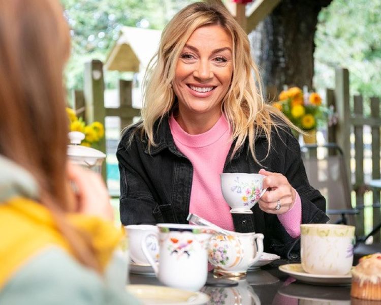 woman having a cup of tea in orchard cafe