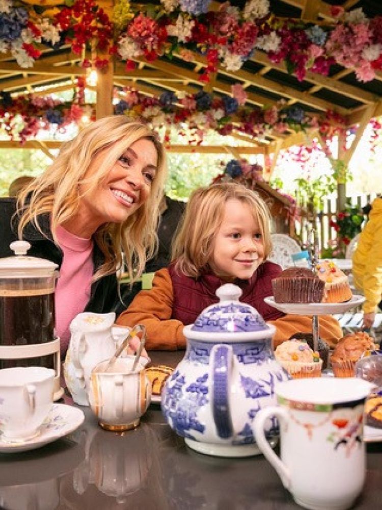 a mum and two kids having tea and cakes in orchard cafe