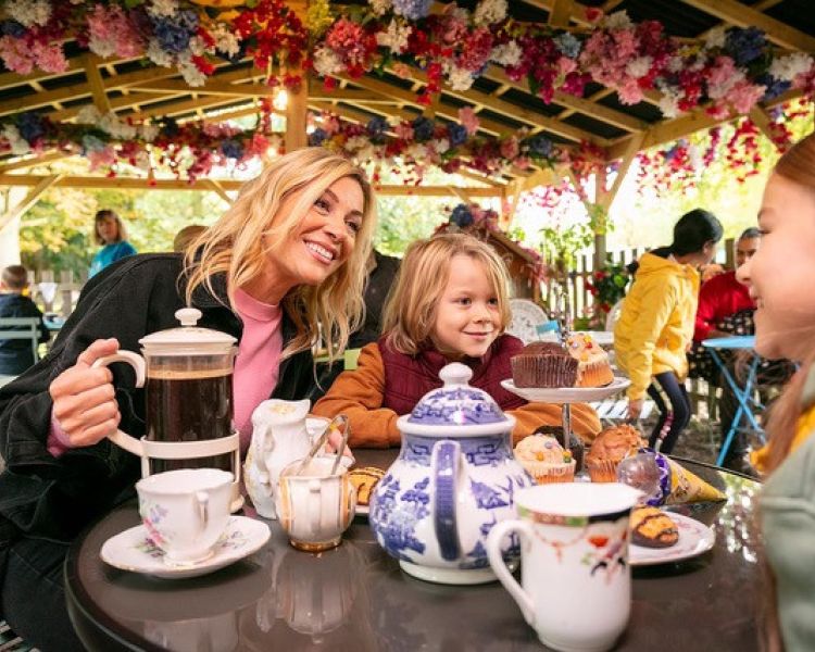 a mum and two kids having tea and cakes in orchard cafe