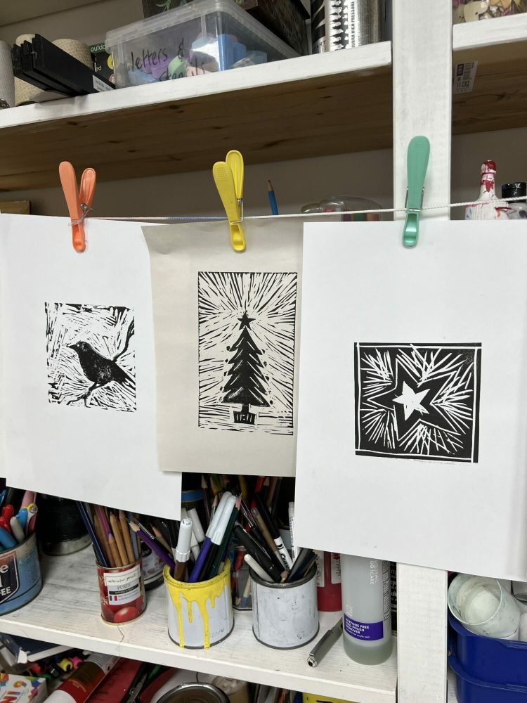 printed lino cut images hanging to dry made on a lino printing workshop