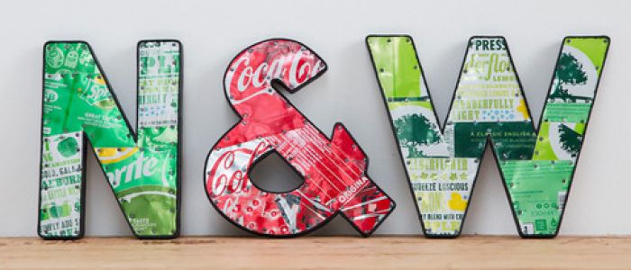 metal letters displayed on shelf made from recycled drinks cans