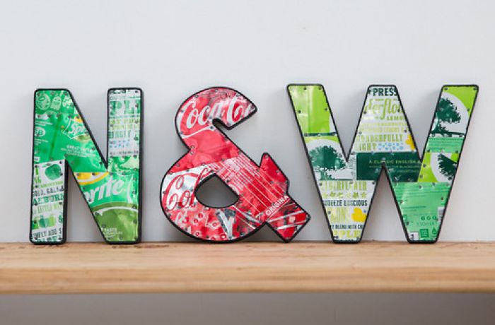 metal letters displayed on shelf made from recycled drinks cans