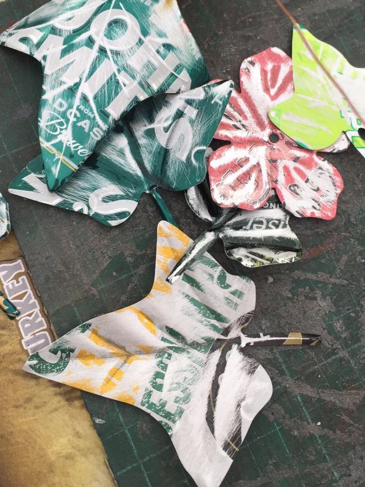 leaf shapes made from recycled metal drinks cans on a craft workshop