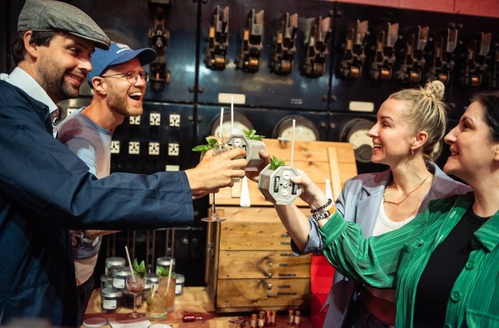 four people drinking cocktails at escape the power cut escape room