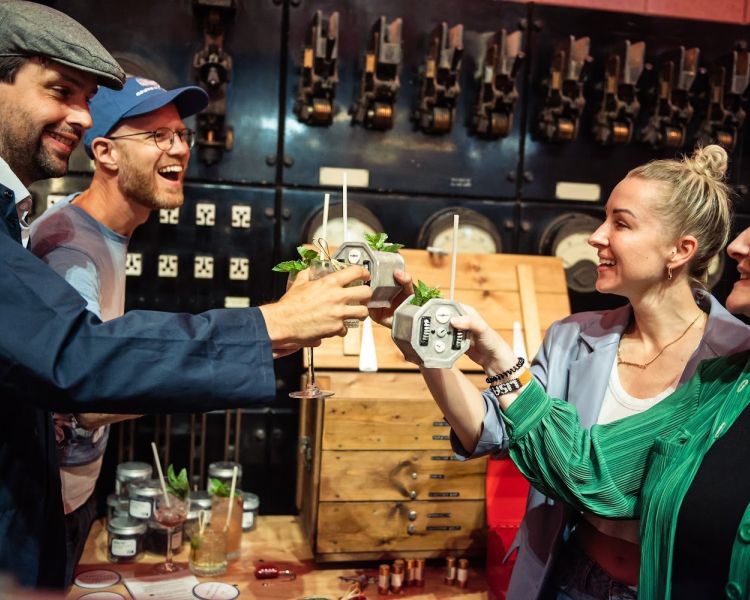 four people drinking cocktails at escape the power cut escape room