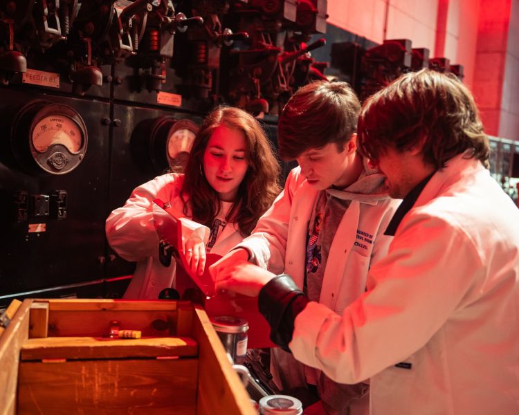 group looking at clues at the escape the power cut escape room